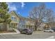 Exterior view of townhomes, showcasing parking area and mature trees, with visitor parking at 8197 S Fillmore Way, Centennial, CO 80122