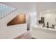 Bright kitchen features white cabinets, quartz counters, stainless appliances and hardwood floors plus open staircase at 8197 S Fillmore Way, Centennial, CO 80122