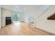 Bright open-concept living area with hardwood floors, a fireplace and natural light from sliding door to back patio at 8197 S Fillmore Way, Centennial, CO 80122