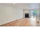 Bright and airy living room with hardwood floors, fireplace, and access to the outdoor patio, ideal for relaxation at 8197 S Fillmore Way, Centennial, CO 80122