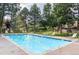 Community pool surrounded by lounge chairs, green trees and lawn at 8197 S Fillmore Way, Centennial, CO 80122