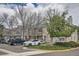 Street view of townhomes with stone accents, landscaping, and on-street parking at 8197 S Fillmore Way, Centennial, CO 80122