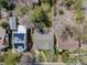 Aerial view of neighborhood, highlighting the house, backyard, nearby streets, and surrounding mature trees at 600 E Amherst Ave, Englewood, CO 80113