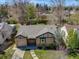 An aerial view of the home showcasing the mature trees, landscaping, brick exterior, roof, and driveway at 600 E Amherst Ave, Englewood, CO 80113