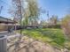 Fully fenced yard with mature landscaping, a storage shed, and a covered patio at 600 E Amherst Ave, Englewood, CO 80113