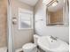 Neutral bathroom featuring a single sink vanity, toilet, tile shower and modern fixtures at 600 E Amherst Ave, Englewood, CO 80113