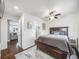 Well-lit bedroom with hardwood floors, ceiling fan, and view to the living room and ensuite at 600 E Amherst Ave, Englewood, CO 80113