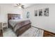 Bedroom with a ceiling fan, large window, hardwood floors, and natural light at 600 E Amherst Ave, Englewood, CO 80113