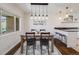 Bright dining area featuring hardwood floors, modern lighting, and backyard view at 600 E Amherst Ave, Englewood, CO 80113