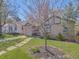 Beautifully landscaped front yard with mature tree and walkway leading to the home at 600 E Amherst Ave, Englewood, CO 80113