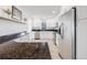 Spacious kitchen featuring granite countertops, white cabinetry, stainless steel appliances, and tile flooring at 600 E Amherst Ave, Englewood, CO 80113