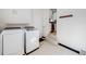 Bright laundry room with modern washer and dryer, and access to the kitchen at 600 E Amherst Ave, Englewood, CO 80113