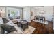 Open-concept living room with hardwood floors and natural light, flowing into the dining area at 600 E Amherst Ave, Englewood, CO 80113
