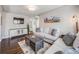 Comfortable living room featuring a cozy sofa, hardwood floors and neutral colors at 600 E Amherst Ave, Englewood, CO 80113