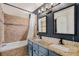 Bathroom with double sink vanity, granite countertop, decorative tile backsplash, and updated fixtures at 2791 S Bahama Ct, Aurora, CO 80013
