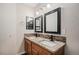Bathroom vanity featuring double sinks, a decorative backsplash, and modern lighting at 2791 S Bahama Ct, Aurora, CO 80013