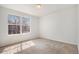 Sunlit bedroom featuring plush carpeting, a large window, and fresh paint at 2791 S Bahama Ct, Aurora, CO 80013