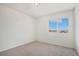 Bright bedroom with a window showcasing neighborhood views and neutral carpet at 2791 S Bahama Ct, Aurora, CO 80013
