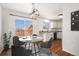 Cozy dining room adjacent to the kitchen features hardwood floors and a modern chandelier at 2791 S Bahama Ct, Aurora, CO 80013