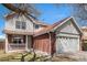 Charming two-story home features a brick facade and a two-car garage and a cozy front porch at 2791 S Bahama Ct, Aurora, CO 80013
