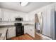 Updated kitchen featuring white cabinets, granite countertops, stainless steel appliances, and tile backsplash at 2791 S Bahama Ct, Aurora, CO 80013