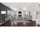 Open-concept living room with ample natural light, a fireplace, and hardwood floors at 2791 S Bahama Ct, Aurora, CO 80013