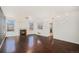Spacious living room with dark hardwood floors, stone fireplace, and large windows at 2791 S Bahama Ct, Aurora, CO 80013