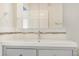 Bathroom featuring a sink with modern fixtures, decorative backsplash and vanity with drawers at 15475 Andrews Dr # 310, Denver, CO 80239