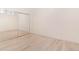 Simple bedroom featuring wood floors, a built-in mirrored closet and a blank white canvas at 15475 Andrews Dr # 310, Denver, CO 80239