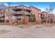 Exterior view of the Towne Square Lofts building showcasing brick facade and surrounding landscaping at 15475 Andrews Dr # 310, Denver, CO 80239
