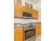 The kitchen showcases a stainless steel oven and microwave, complemented by light wood cabinets and granite countertops at 15475 Andrews Dr # 310, Denver, CO 80239
