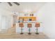 Bright kitchen features wooden cabinets, stainless steel appliances, and a breakfast bar with three stools at 15475 Andrews Dr # 310, Denver, CO 80239