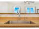 The kitchen features an undermount stainless steel sink and a high-arc faucet under large bright windows at 15475 Andrews Dr # 310, Denver, CO 80239