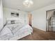 Bedroom with brown carpet, a ceiling light and a patterned bed spread at 9667 W Ohio Ave, Lakewood, CO 80226