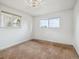 Spare bedroom with a brown carpet and two windows providing natural light at 9667 W Ohio Ave, Lakewood, CO 80226