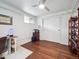 Bedroom featuring wood floors, white walls, ceiling fan and closet at 9667 W Ohio Ave, Lakewood, CO 80226