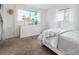 Bedroom featuring a white dresser, soft carpet, and natural light at 9667 W Ohio Ave, Lakewood, CO 80226