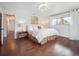Bright bedroom featuring hardwood floors, a large window, and a stylish light fixture at 9667 W Ohio Ave, Lakewood, CO 80226