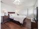 Cozy bedroom with hardwood floors, a ceiling light, and matching nightstands at 9667 W Ohio Ave, Lakewood, CO 80226