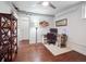 Bedroom featuring wood floors, white walls, ceiling fan and closet at 9667 W Ohio Ave, Lakewood, CO 80226