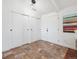 Inviting entryway featuring slate flooring, ample closet space, and stylish modern lighting fixture at 9667 W Ohio Ave, Lakewood, CO 80226