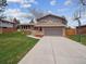 A well-maintained home shows a spacious driveway and a basketball hoop in the yard at 9667 W Ohio Ave, Lakewood, CO 80226