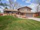 Charming two-story home featuring a well-manicured lawn and a two-car garage at 9667 W Ohio Ave, Lakewood, CO 80226