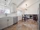 Bright kitchen boasts stainless steel appliances and modern white cabinetry at 9667 W Ohio Ave, Lakewood, CO 80226