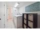 Functional laundry room with modern washer and dryer, tiled floor and storage shelving at 9667 W Ohio Ave, Lakewood, CO 80226