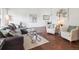 Bright living room features hardwood floors, large windows, and stylish furnishings at 9667 W Ohio Ave, Lakewood, CO 80226