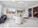 Bright sunroom featuring white carpet, white chairs and couch, and large windows at 9667 W Ohio Ave, Lakewood, CO 80226