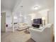Spacious basement living area with a comfortable sofa, large TV, and neutral carpet at 9667 W Ohio Ave, Lakewood, CO 80226