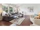 Inviting living room features a comfortable sectional sofa and a glass coffee table at 9667 W Ohio Ave, Lakewood, CO 80226