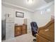 Basement home office featuring built-in desk, neutral carpet and white walls at 9667 W Ohio Ave, Lakewood, CO 80226